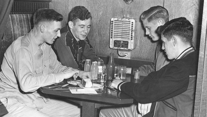 1949: Le Mars players (from left) Dwight Wolbers, Jim Schultz, Eldon Clement and Jim Lorenzen diagram a play using a salt shaker, milk bottles and ketchup bottle.