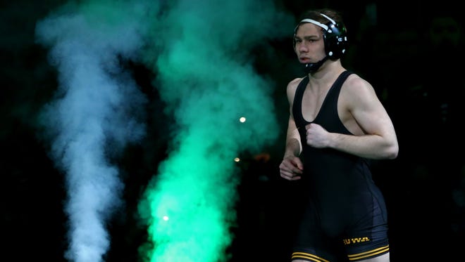 Mar 17, 2018; Cleveland, OH, USA; Iowa Hawkeyes wrester Spencer Lee heading to the mat to face Rutgers Scarlet Knights wrestler Nick Suriano during the NCAA Wrestling DI Wrestling Championships final at Quicken Loans Arena.