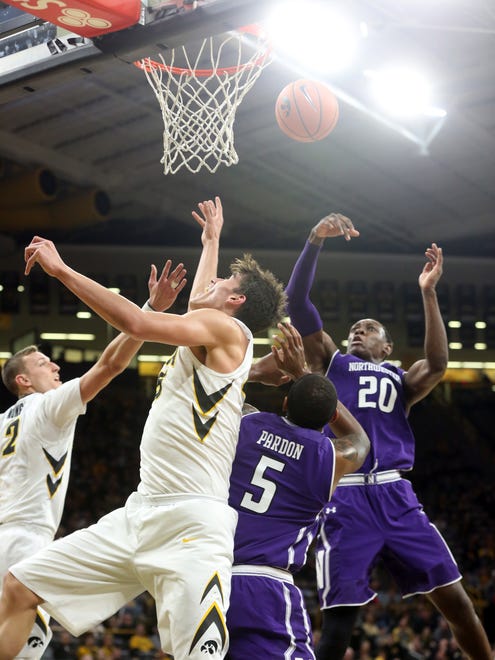Hawkeyes and Wildcats fight for a rebound during their game at Carver-Hawkeye Arena on Sunday, Feb. 25, 2018.