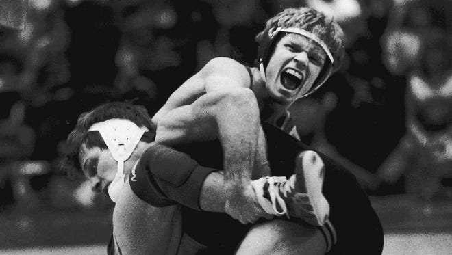 1986: Joe Gibbons, right, who wrestled for Waterloo Columbus and Ames, became the fourth athlete to win a fourth state title in 1981. In this photo, he wrestles for Iowa State, with the opponent being Iowa's Kevin Dresser.