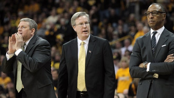 Iowa head coach Fran McCaffery, center, and assistant coaches Kirk Speraw, left, and Sherman Dillard, right, call to players during their second-round NIT game against Stony Brook at Carver-Hawkeye Arena on Friday, March 22, 2013.