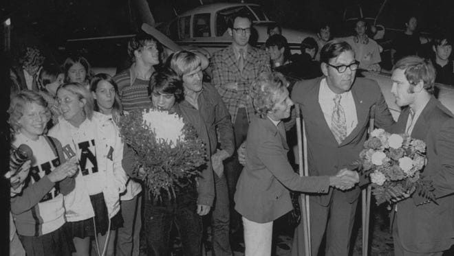 In this 1972 photo, the mayor of Waterloo (Lloyd Turner) and his wife greet Olympic gold medal winner Dan Gable on his return home from Munich, Germany. A small group waited outside the Waterloo airport for the plane that arrived at 2:30 a.m.