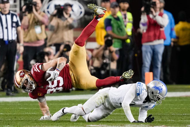 San Francisco 49ers tight end George Kittle is tackled by Detroit Lions cornerback Cameron Sutton during the second half of the NFC Championship NFL football game in Santa Clara, Calif., Sunday, Jan. 28, 2024. (AP Photo/David J. Phillip)