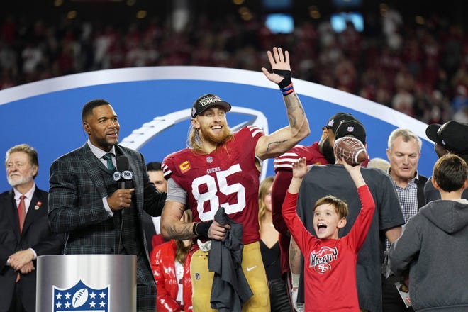 San Francisco 49ers tight end George Kittle celebrates alongside Fox Sports' Michael Strahan after winning the NFC championship game over the Detroit Lions.