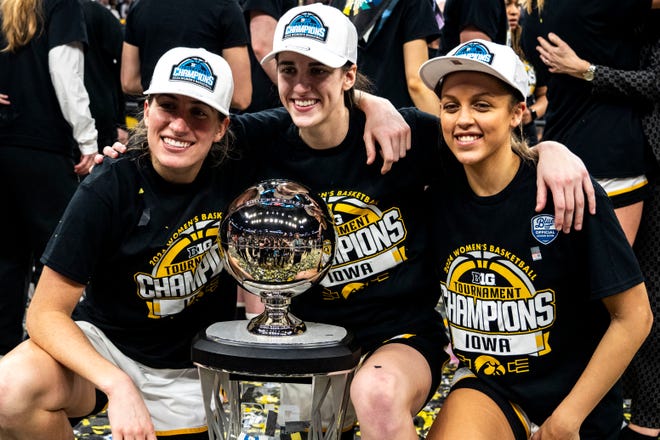 Iowa guard Kate Martin (20), Iowa guard Caitlin Clark (22) and Iowa guard Gabbie Marshall (24) pose for a photo after the Big Ten Tournament championship game at the Target Center on Sunday, March 10, 2024, in Minneapolis, Minn.