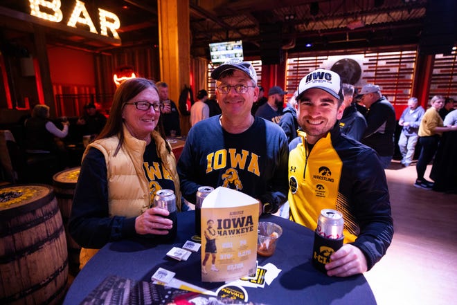 Clint Matthews of Austin, TX and Sue and Andy Matthews of Nashua attend the Hawkeye Huddle ahead of the NCAA championship semi final round Friday, March 22, 2024, at the Power and Light District in Kansas City, MO.