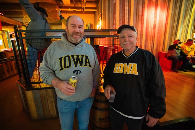 Mike Kellor of Muscatine, IA and Jarald Harter of Hedrick attend the Hawkeye Huddle ahead of the NCAA championship semi final round Friday, March 22, 2024, at the Power and Light District in Kansas City, MO.
