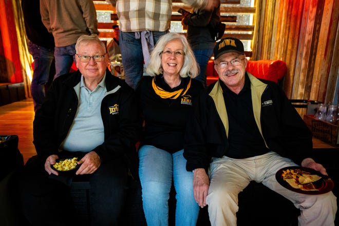 Bob and Sue Dane of Iowa City with Steve Downes of Oxford, IA attend a Hawkeye Huddle ahead of the NCAA championships semifinal round Friday, March 22, 2024, at the Power and Light District in Kansas City, MO.