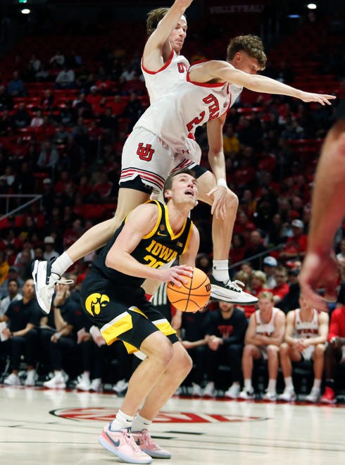 SALT LAKE CITY, UT - MARCH 24: Brandon Carlson #35 and Cole Bajema #2 of the Utah Utes leave their feet as Payton Sandfort #20 of the Iowa Hawkeyes looks to shoot during the first half of the second round of the men's basketball National Invitation Tournament (NIT) at the Jon M Huntsman Center on March 24, 2024 in Salt Lake City Utah. (Photo by Chris Gardner/Getty Images)