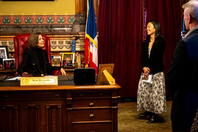 Iowa Gov. Kim Reynolds speaks with Iowa women's wrestling head coach Clarissa Chun during a proclamation signing declaring April 3 as University of Iowa Women's Wrestling Day in the state of Iowa on Wednesday, April 3, 2024, in Des Moines.