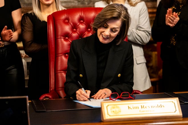 Iowa Gov. Kim Reynolds signs a proclamation declaring April 3 as University of Iowa Women's Wrestling Day, in the state of Iowa, while surrounded by members of the team and staff on Wednesday, April 3, 2024, in Des Moines.