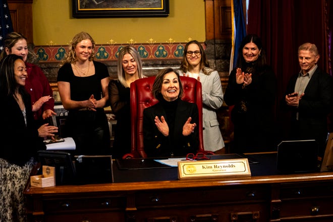 Iowa Gov. Kim Reynolds and Iowa women's wrestling athletes and staff applaud during a proclamation signing declaring April 3 as University of Iowa Women's Wrestling Day in the state of Iowa on Wednesday, April 3, 2024, in Des Moines.