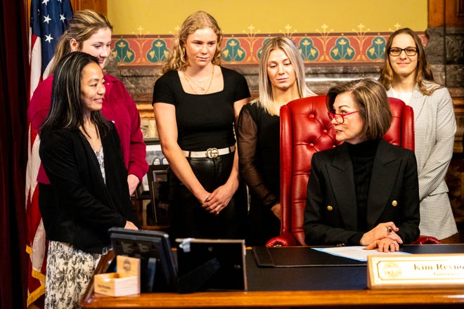 Iowa Gov. Kim Reynolds reads a proclamation declaring April 3 as University of Iowa Women's Wrestling Day, in the state of Iowa, while surrounded by members of the team and staff on Wednesday, April 3, 2024, in Des Moines.