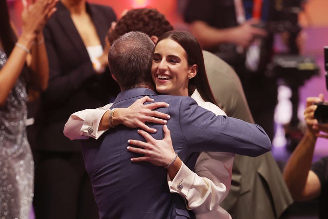 Apr 15, 2024; Brooklyn, NY, USA; Caitlin Clark embraces her father Brent Clark after she is selected with the number one overall pick to the Indiana Fever in the 2024 WNBA Draft at Brooklyn Academy of Music. Mandatory Credit: Brad Penner-USA TODAY Sports