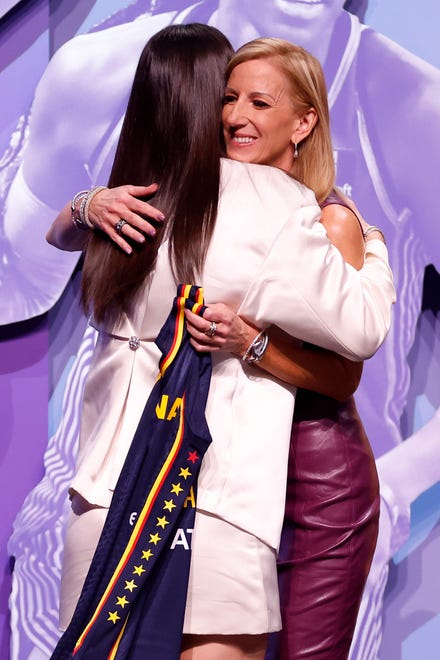 NEW YORK, NEW YORK - APRIL 15: Caitlin Clark hugs WNBA Commissioner Cathy Engelbert after being selected first overall pick by the Indiana Fever during the 2024 WNBA Draft at Brooklyn Academy of Music on April 15, 2024 in New York City. (Photo by Sarah Stier/Getty Images)