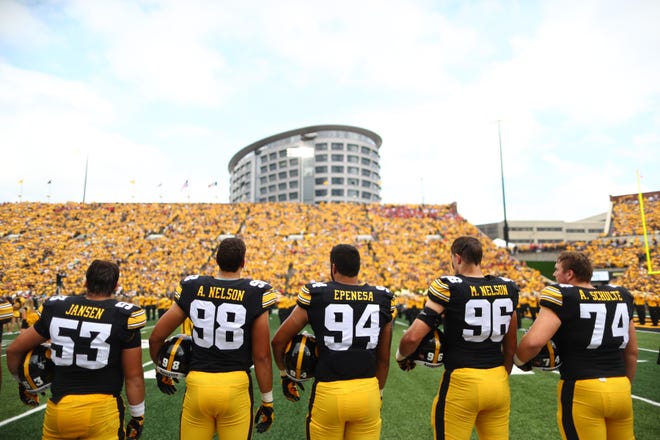 Iowa's Garret Jansen, from left, Anthony Nelson, A.J. Epenesa, Matt Nelson and Austin Schulte stand for the national anthem before the Hawkeyes' game against Northern Illinois at Kinnick Stadium on Satuday, Sept. 1, 2018.