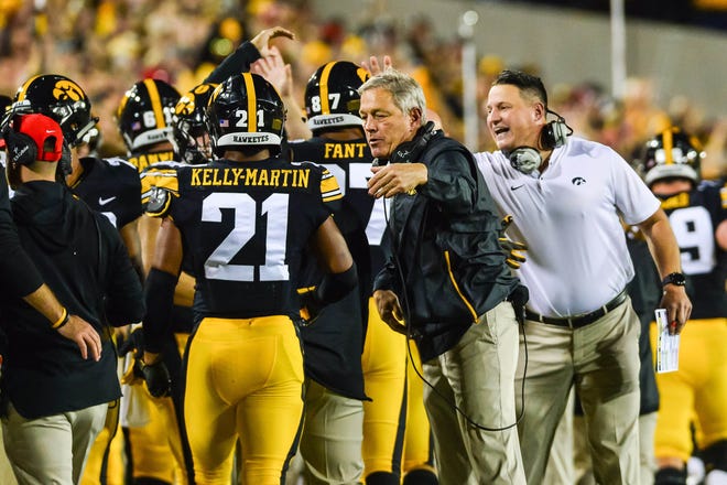 Iowa head coach Kirk Ferentz and assistant coach Brian Ferentz react with running back Ivory Kelly-Martin (21) during the Wisconsin game. The Hawkeyes have tweaked their bye-week routine a little bit with hopes of getting an improved showing over past years.
