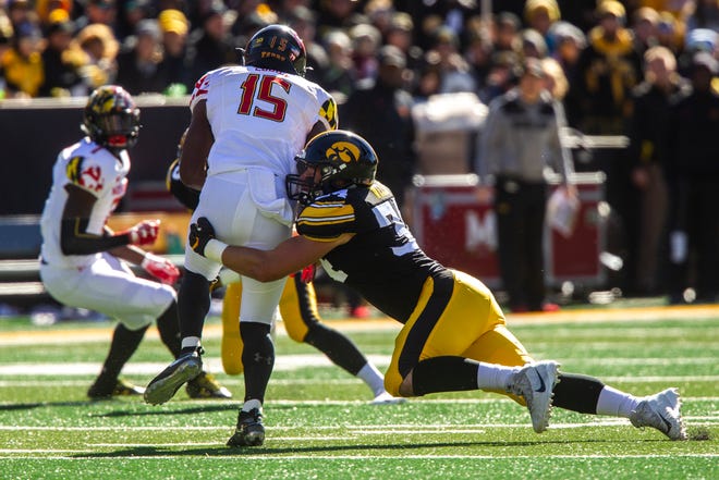Iowa linebacker Kristian Welch tackles Maryland wide receiver Brian Cobbs during a game on Oct. 20, 2018 in Iowa City.