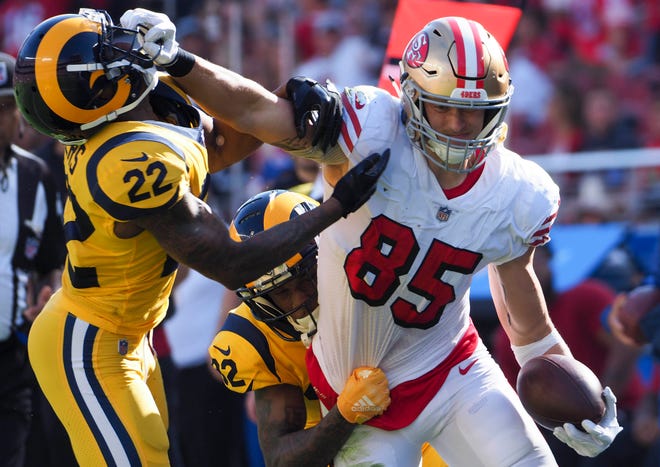 San Francisco 49ers tight end George Kittle holds off Los Angeles Rams cornerback Marcus Peters during the second quarter at Levi's Stadium.
