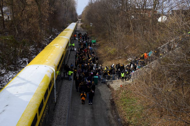 Football fans disembark from the Hawkeye Express before the Iowa-Northwestern football game on November 10, 2018.