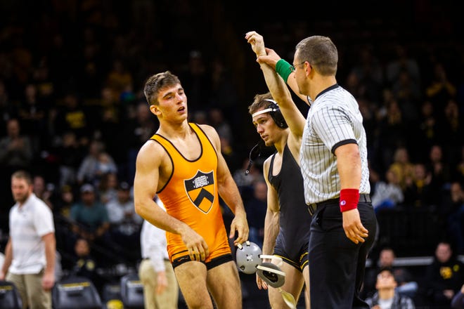 Iowa's Spencer Lee has his hand raised after scoring a tech fall Princeton's Patrick Glory at 125 during an NCAA wrestle dual on Friday, Nov. 16, 2018, at Carver-Hawkeye Arena in Iowa City.