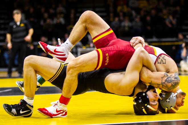Iowa's Spencer Lee, bottom, wrestles Iowa State's Alex Mackall at 125 during a NCAA Cy-Hawk series wrestling dual on Saturday, Dec. 1, 2018, at Carver-Hawkeye Arena in Iowa City.