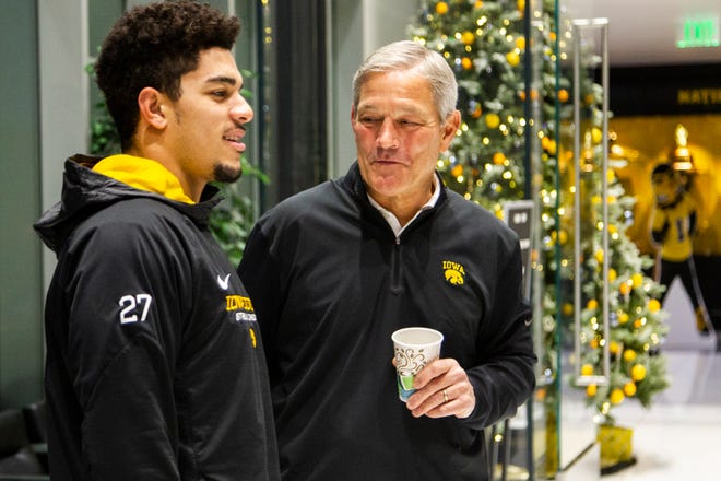 Iowa head coach Kirk Ferentz talks with Iowa defensive back Amani Hooker, left, during an Outback Bowl announcement press conference on Sunday, Dec. 2, 2018, at the Hansen Football Performance Center in Iowa City.