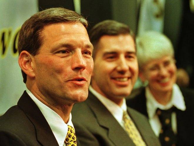 New Iowa Hawkeyes football coach Kirk Ferentz, left, answers a question at a press conference announcing his appointment on Dec. 3, 1998. With him are UI Athletic Director Bob Bowlsby and UI President Mary Sue Coleman.