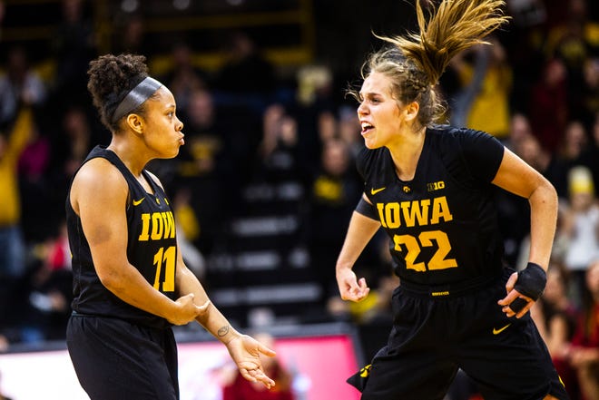 Iowa guard Tania Davis (11) celebrates after making a 3-point basket with Iowa guard Kathleen Doyle (22) during a Cy-Hawk series NCAA women's basketball game on Wednesday, Dec. 5, 2018, at Carver-Hawkeye Arena in Iowa City.