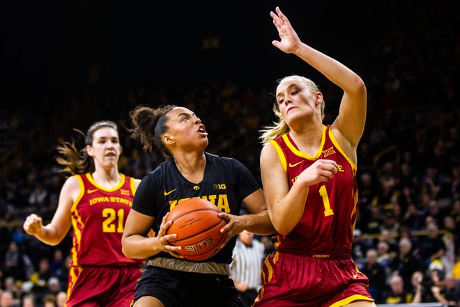 Iowa guard Alexis Sevillian (5) drives to the basket past Iowa State forward Madison Wise (1) during a Cy-Hawk series NCAA women's basketball game on Wednesday, Dec. 5, 2018, at Carver-Hawkeye Arena in Iowa City.
