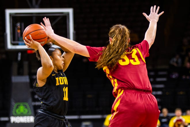 Iowa guard Tania Davis (11) passes during a Cy-Hawk series NCAA women's basketball game on Wednesday, Dec. 5, 2018, at Carver-Hawkeye Arena in Iowa City.