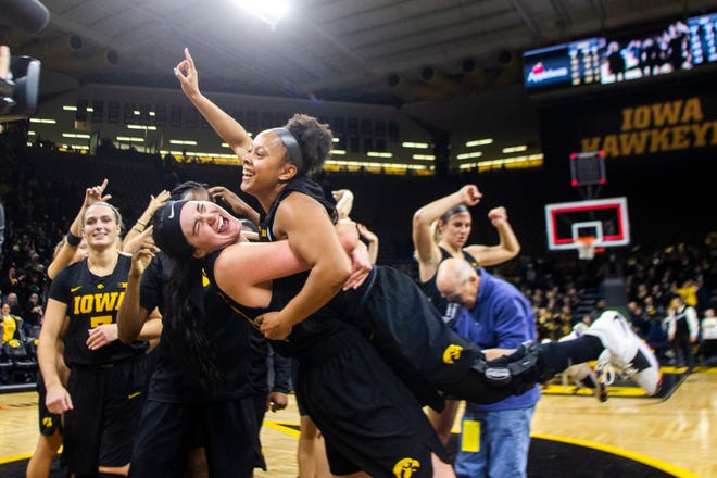 Iowa forward Megan Gustafson (10) embraces Iowa guard Tania Davis (11) after a Cy-Hawk series NCAA women's basketball game on Wednesday, Dec. 5, 2018, at Carver-Hawkeye Arena in Iowa City. The Hawkeyes defeated the Cyclones, 73-70.