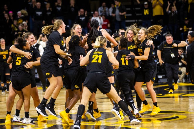 Iowa Hawkeyes players celebrate after a Cy-Hawk series NCAA women's basketball game on Wednesday, Dec. 5, 2018, at Carver-Hawkeye Arena in Iowa City. The Hawkeyes defeated the Cyclones, 73-70.