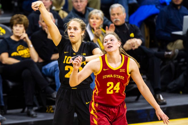 Iowa guard Kathleen Doyle (22) watches as her 3-point basket lands while being defended by Iowa State guard Ashley Joens (24) during a Cy-Hawk series NCAA women's basketball game on Wednesday, Dec. 5, 2018, at Carver-Hawkeye Arena in Iowa City.