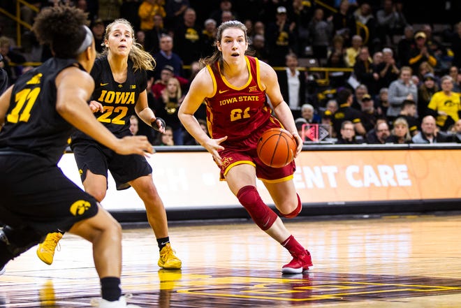 Iowa State guard Bridget Carleton (21) drives in the paint past Iowa guard Kathleen Doyle (22) during a Cy-Hawk series NCAA women's basketball game on Wednesday, Dec. 5, 2018, at Carver-Hawkeye Arena in Iowa City.