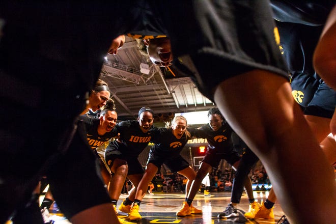 Iowa Hawkeyes players huddle up after introductions before a Cy-Hawk series NCAA women's basketball game on Wednesday, Dec. 5, 2018, at Carver-Hawkeye Arena in Iowa City.