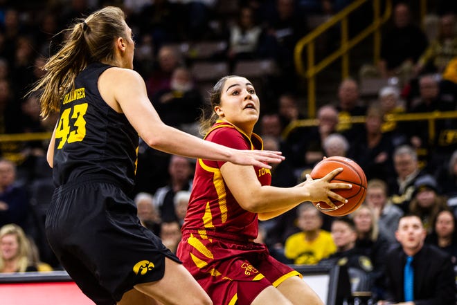 Iowa State guard Rae Johnson (4) drives to the hoop past Iowa forward Amanda Ollinger (43) during a Cy-Hawk series NCAA women's basketball game on Wednesday, Dec. 5, 2018, at Carver-Hawkeye Arena in Iowa City.
