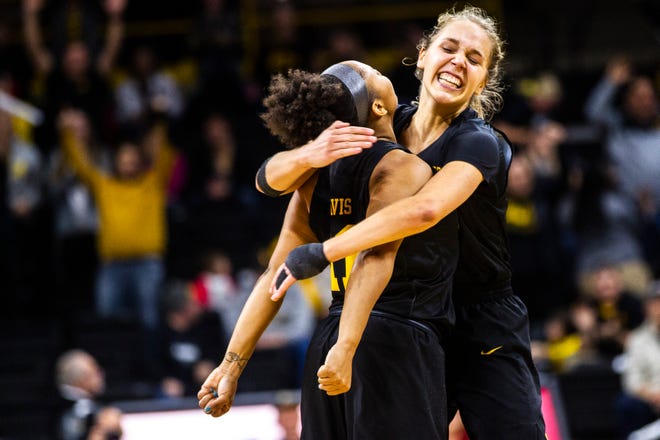 Iowa guard Kathleen Doyle (right) embraces Iowa guard Tania Davis after she made a 3-point basket during a Cy-Hawk series NCAA women's basketball game on Wednesday, Dec. 5, 2018, at Carver-Hawkeye Arena in Iowa City.