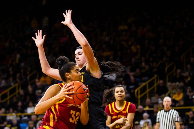 Iowa State forward Meredith Burkhall (32) gets defended by Iowa forward Megan Gustafson (10) in the paint during a Cy-Hawk series NCAA women's basketball game on Wednesday, Dec. 5, 2018, at Carver-Hawkeye Arena in Iowa City.