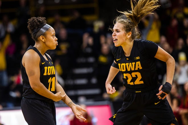 Iowa guard Tania Davis (11) celebrates with Iowa guard Kathleen Doyle (22) after making a 3-point basket during a Cy-Hawk series NCAA women's basketball game on Wednesday, Dec. 5, 2018, at Carver-Hawkeye Arena in Iowa City.