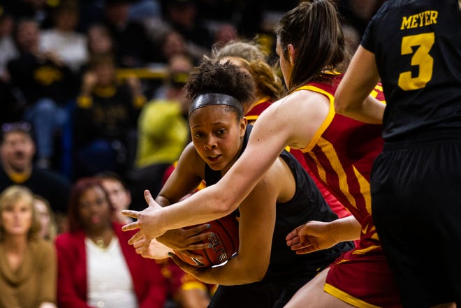 Iowa guard Tania Davis (11) gets defended in the paint by Iowa State guard Bridget Carleton (21) during a Cy-Hawk series NCAA women's basketball game on Wednesday, Dec. 5, 2018, at Carver-Hawkeye Arena in Iowa City.