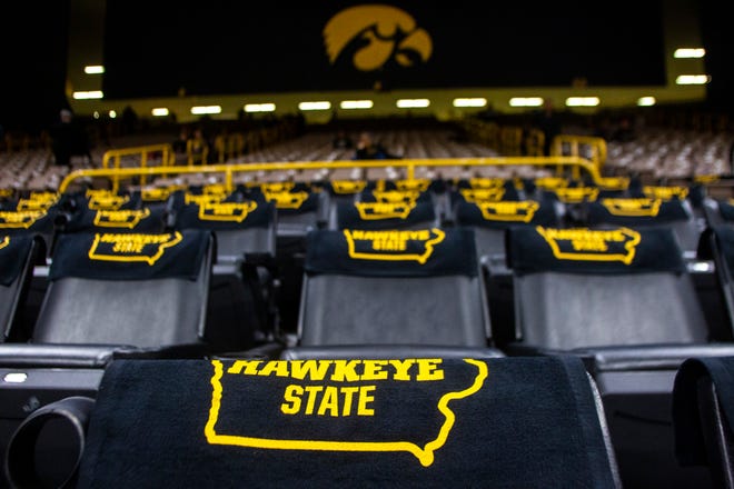 Rally towels that feature the outline of the state of Iowa and the words "The Hawkeye State" lay on seats in the lower bowl before a Cy-Hawk series NCAA women's basketball game on Wednesday, Dec. 5, 2018, at Carver-Hawkeye Arena in Iowa City.