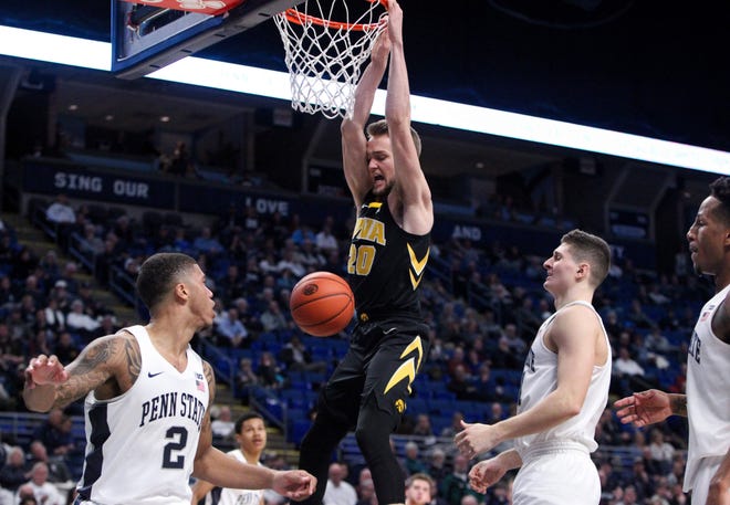 Jan 16, 2019; University Park, PA, USA; Iowa Hawkeyes forward Riley Till (20) hangs on the rim after dunking the ball during the second half against the Penn State Nittany Lions at Bryce Jordan Center. Iowa defeated Penn State 89-82. Mandatory Credit: Matthew O'Haren-USA TODAY Sports