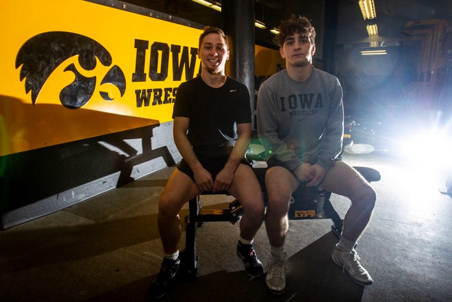 Iowa's 125-pound Spencer Lee and 133-pound Austin DeSanto sit for a photo on Monday, Feb. 11, 2019 inside the Dan Gable Wrestling Complex at Carver-Hawkeye Arena in Iowa City, Iowa.