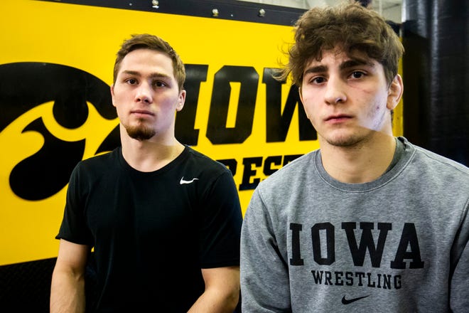 Iowa's 125-pound Spencer Lee and 133-pound Austin DeSanto sit for a photo on Monday, Feb. 11, 2019 inside the Dan Gable Wrestling Complex at Carver-Hawkeye Arena in Iowa City, Iowa.
