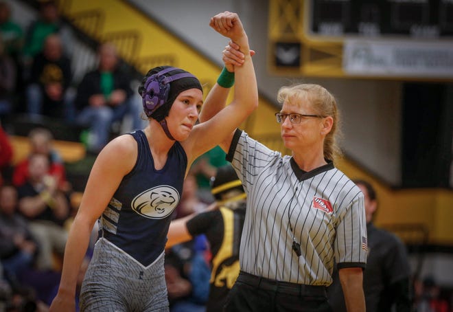 Wrestling official Nadine Ihde, shown at right in a file photo from the first ever Iowa high school girls state wrestling tournament, is the first female to ever officiate a state wrestling match.
