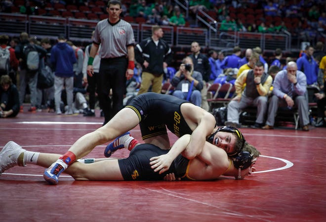 Waverly-Shell Rock's Evan Yant works to control Southeast Polk's Carson Martinson at 132 pounds during the 2019 Iowa high school dual wrestling state tournament on Wednesday, Feb. 13, 2019, at Wells Fargo Arena in Des Moines.