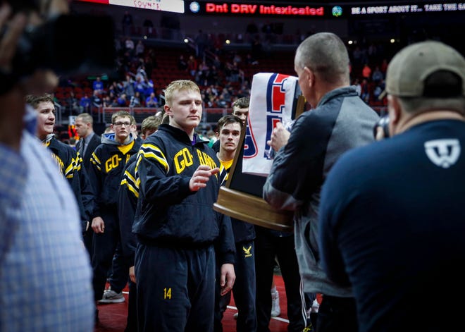 Members of the Waverly-Shell Rock wrestling team take the Class 3A runner up trophy during the 2019 Iowa high school dual wrestling state tournament on Wednesday, Feb. 13, 2019, at Wells Fargo Arena in Des Moines.