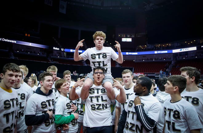Members of the Southeast Polk wrestling team celebrate a Class 3A state title win over Waverly-Shell Rock during the 2019 Iowa high school dual wrestling state tournament on Wednesday, Feb. 13, 2019, at Wells Fargo Arena in Des Moines.