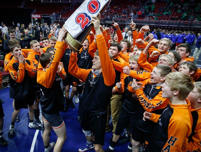 Members of the West Delaware wrestling team celebrate a Class 2A title during the 2019 Iowa high school dual wrestling state tournament on Wednesday, Feb. 13, 2019, at Wells Fargo Arena in Des Moines.